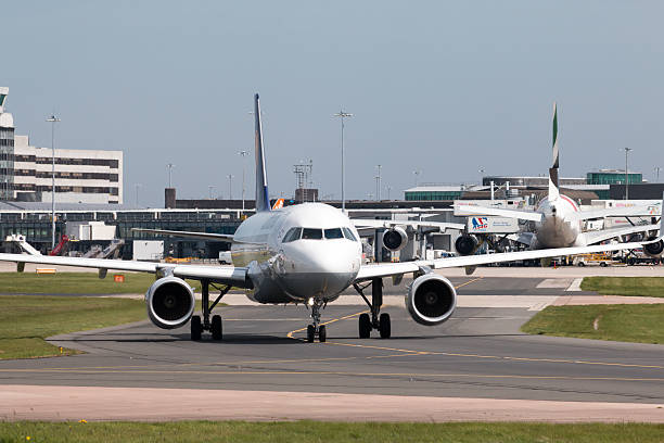 Manchester, United Kingdom - May 8, 2016: Lufthansa A319-100 narrow-body passenger plane (D-AIZY) taxiing on Manchester International Airport tarmac.