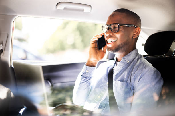 Luxury Taxi Conversation: African CEO and American Executive Discuss Global Business Ventures While Traveling in Style with Technology.